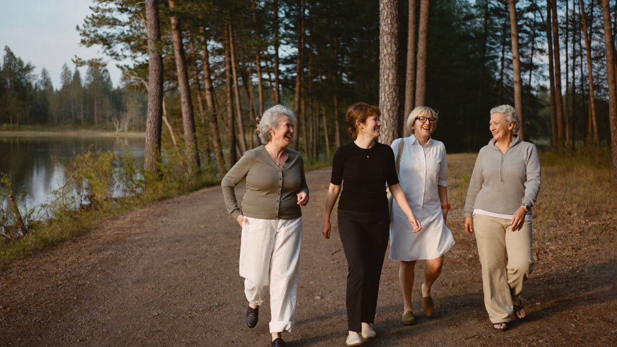 Friends walking a lakeside trail